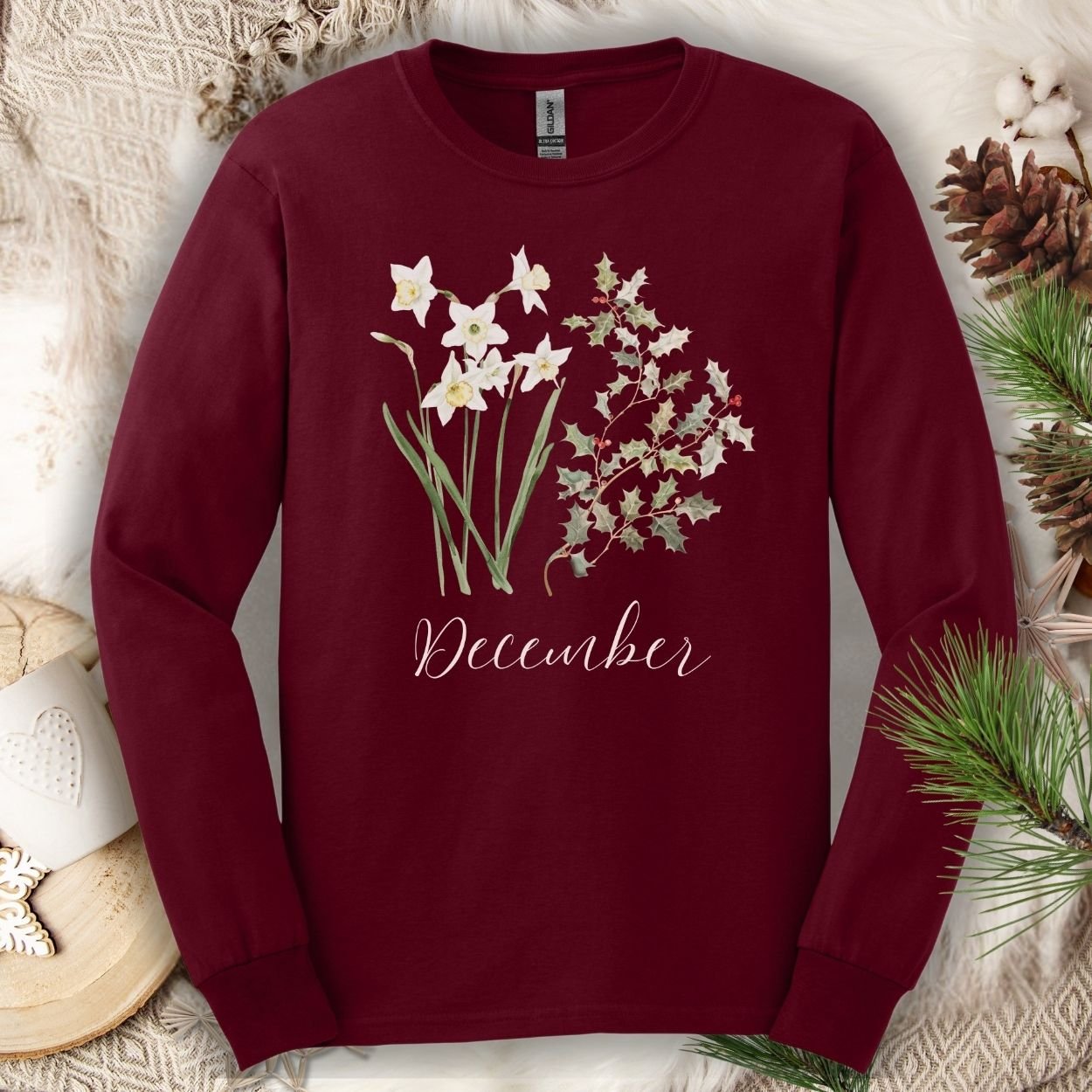 Maroon long sleeve tee with watercolor narcissus, holly berries, and "December" script.
