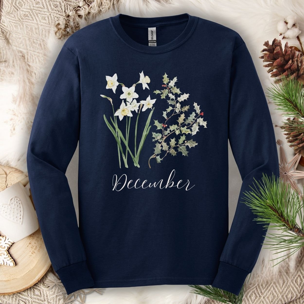 Navy long-sleeve tee with watercolor narcissus, holly, and "December" script.