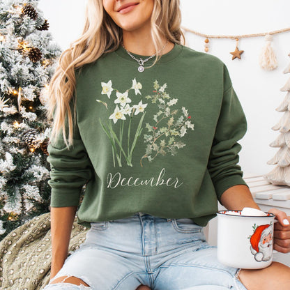 Olive green unisex sweatshirt with white narcissus, holly berry design, and "December" script.