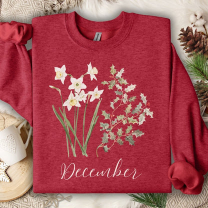 Antique Cherry Red unisex sweatshirt with watercolor narcissus, holly, and "December" text.