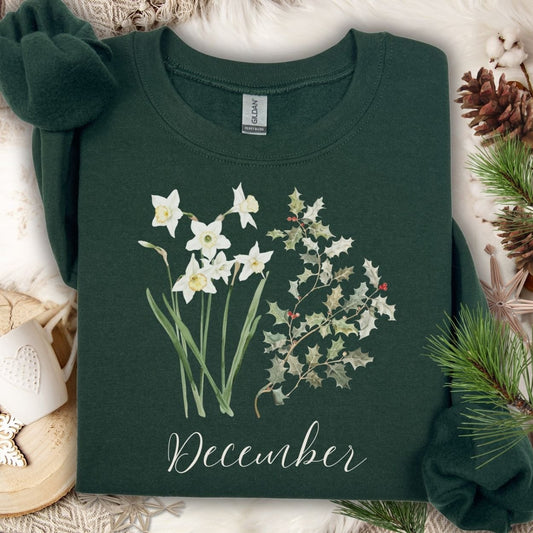 Forest Green unisex sweatshirt with watercolor narcissus, holly, and "December" text.