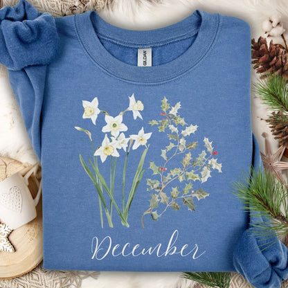 Indigo blue crewneck sweatshirt with watercolor narcissus, holly, and "December" text.