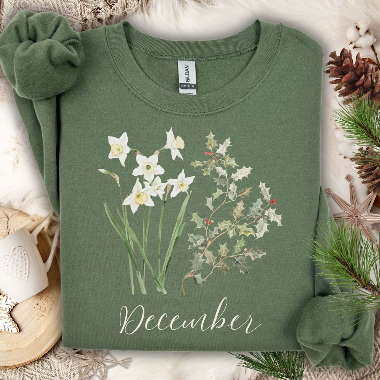 Military Green unisex sweatshirt with watercolor narcissus, holly, and "December" text.