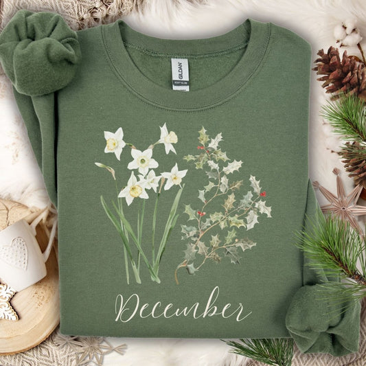 Military Green unisex sweatshirt with watercolor narcissus, holly, and "December" text.
