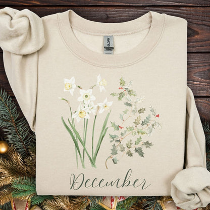 Sand unisex sweatshirt with watercolor narcissus, holly, and "December" script.