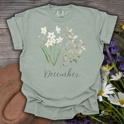 Bay green garment-dyed cotton t-shirt with watercolor narcissus, holly, and "December" script.