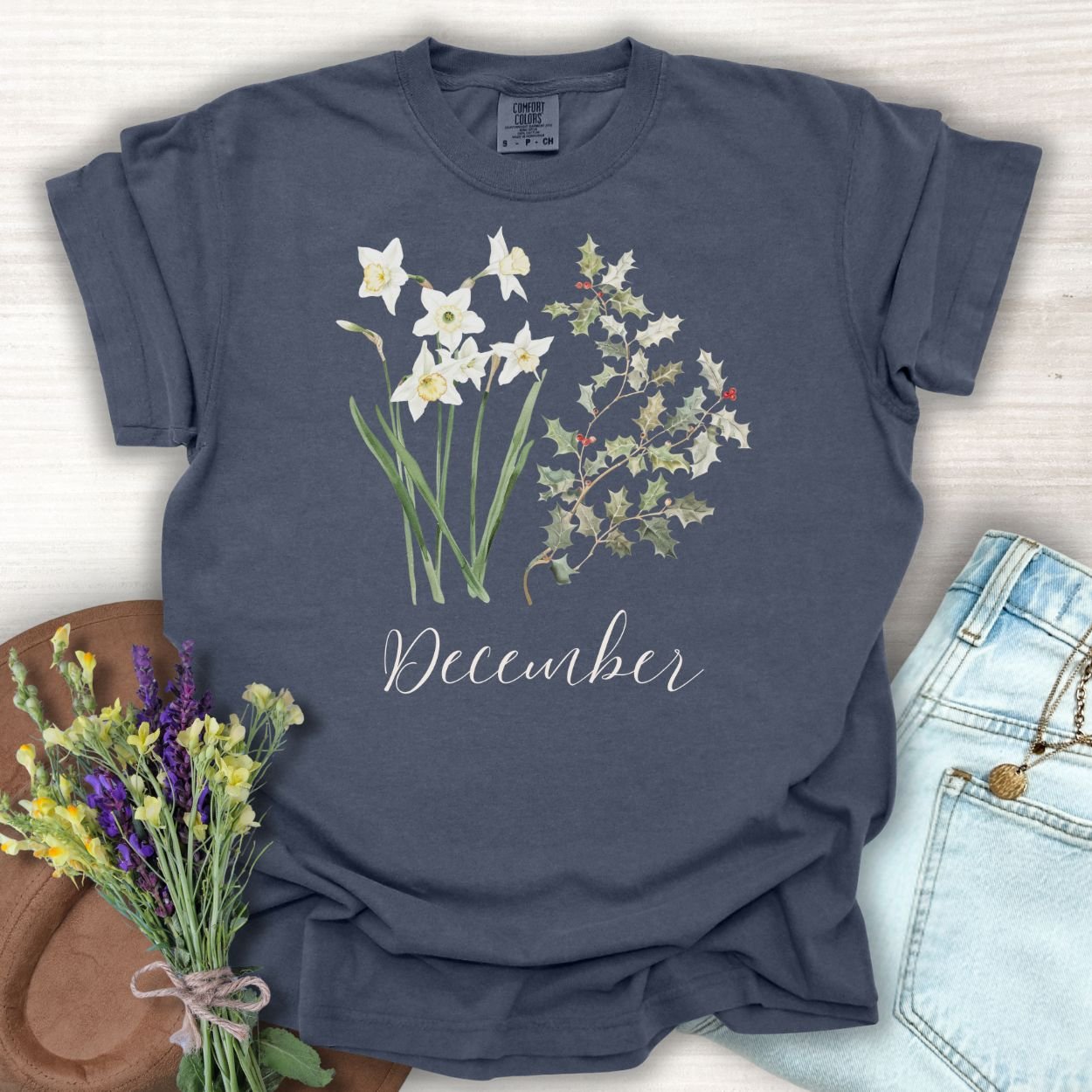 Denim S t-shirt with watercolor narcissus, holly, and "December" script.