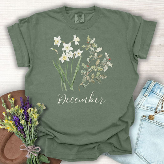 Moss green cotton t-shirt with watercolor narcissus, holly, and "December" script.