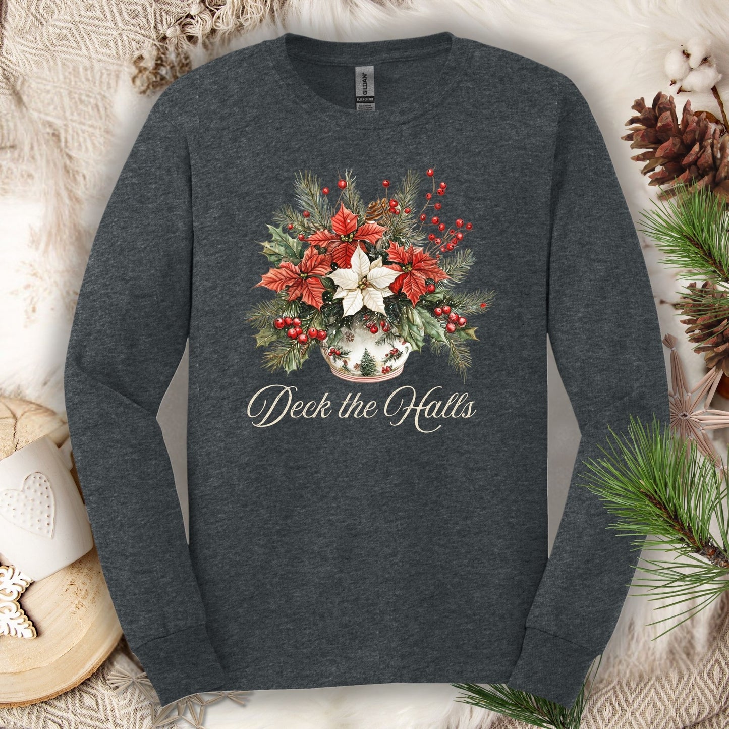 Dark heather long sleeve tee with watercolor poinsettias, evergreens, berries, and "Deck the Halls" script.