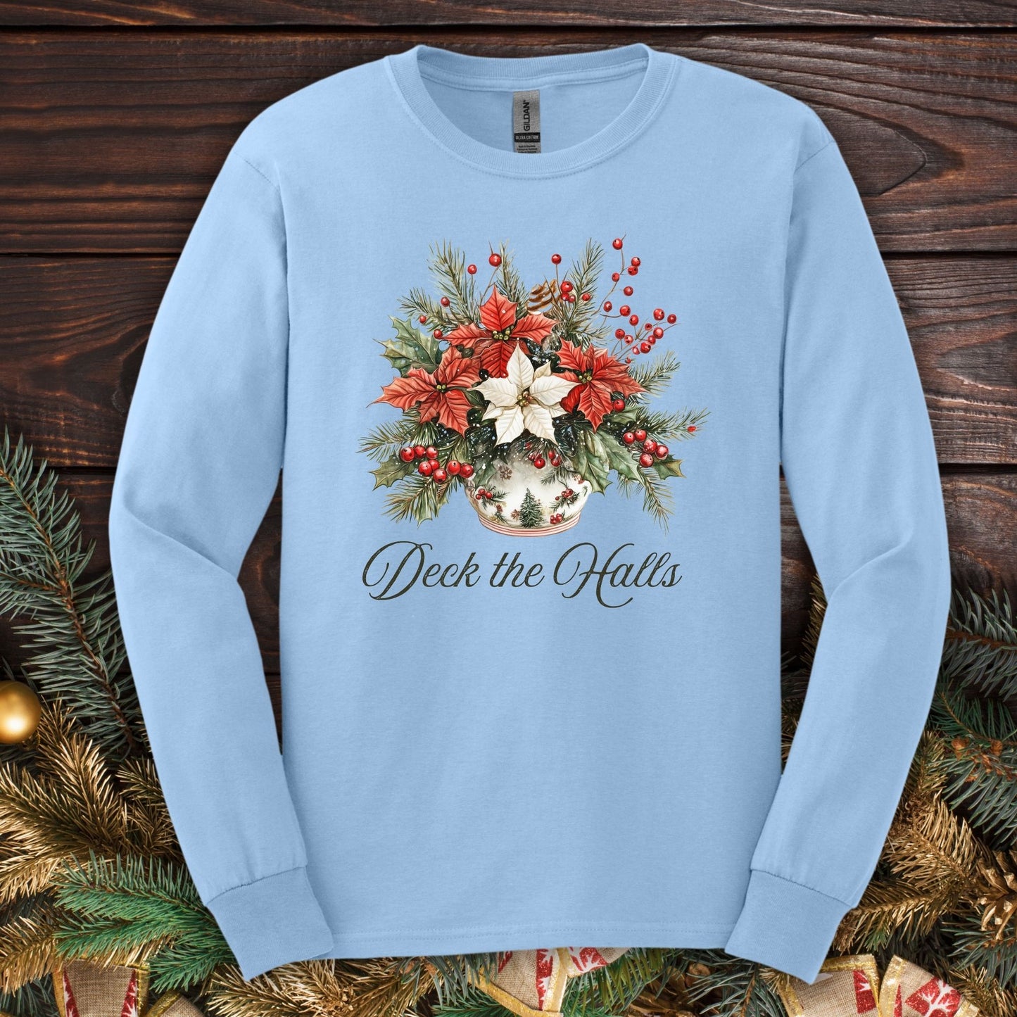 Light blue Gildan long sleeve tee with a watercolor poinsettia arrangement and "Deck the Halls" script.