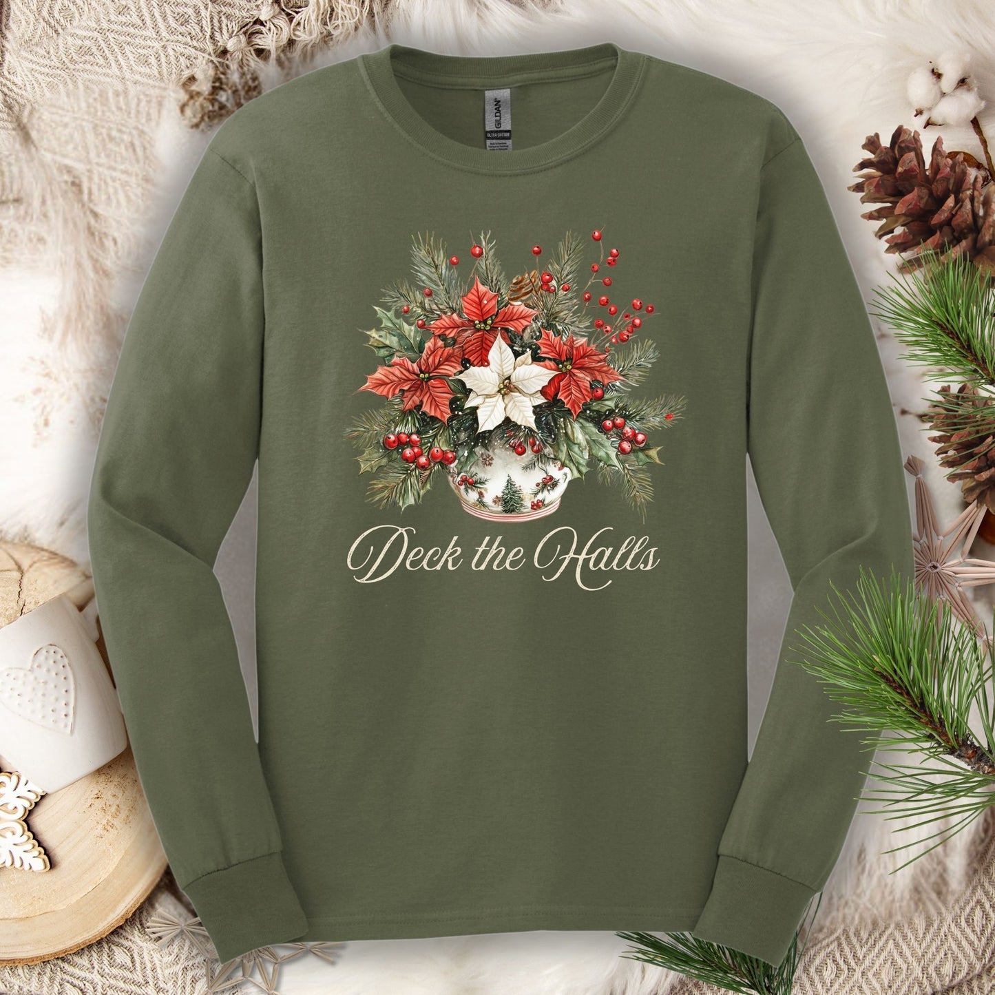 Military Green long sleeve tee with watercolor poinsettias, evergreens, berries, and "Deck the Halls" script.