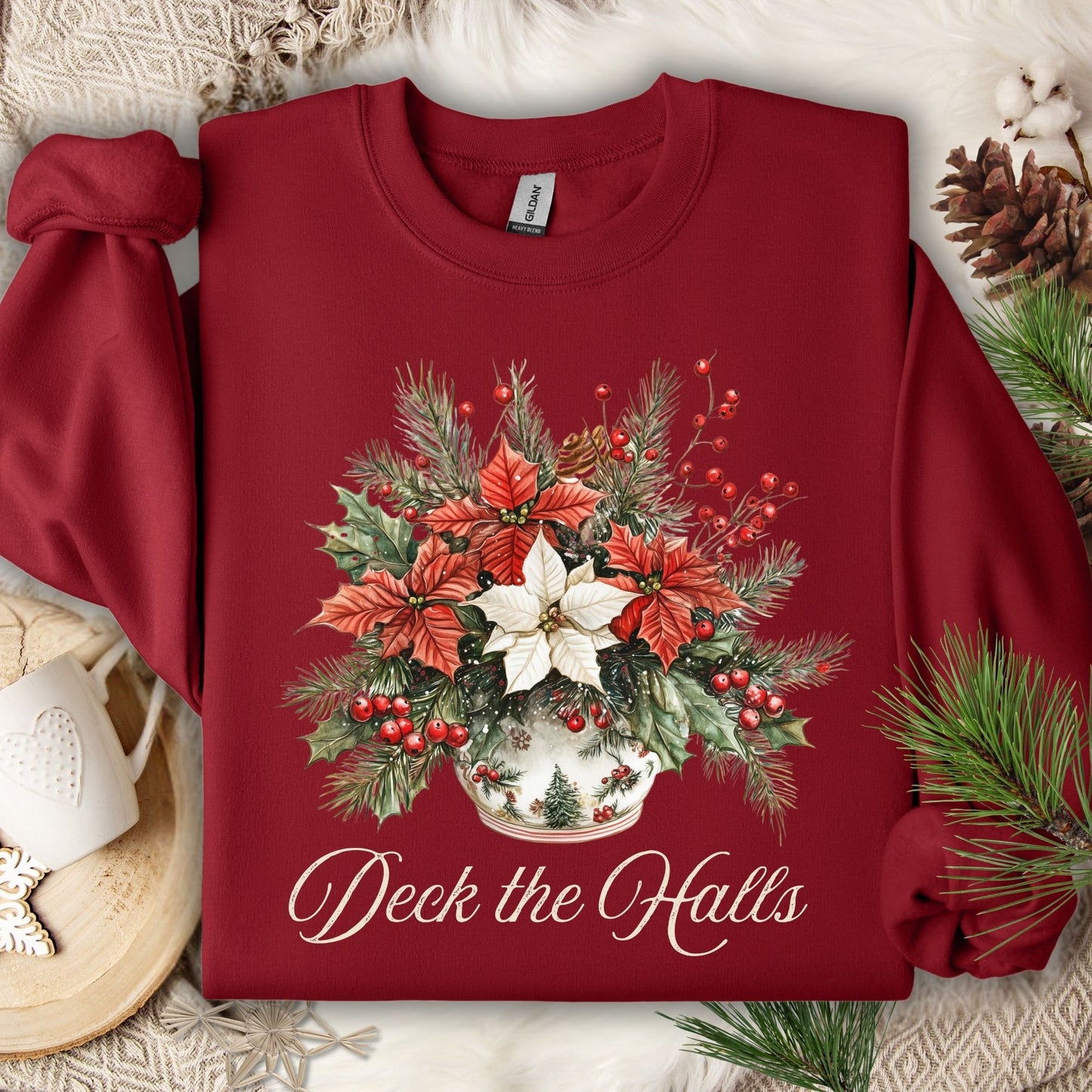 Cardinal Red Gildan sweatshirt with a watercolor poinsettia bouquet in a vase and "Deck the Halls" text.