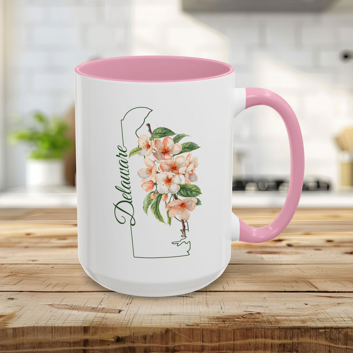 15oz white ceramic mug with pink handle/interior, featuring Delaware outline and peach blossom watercolor art.