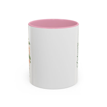 White ceramic mug with pink interior and handle, featuring a watercolor peach blossom design and "Delaware" text.