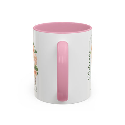 White ceramic mug with pink interior and handle, featuring peach blossom art and "Delaware" text.