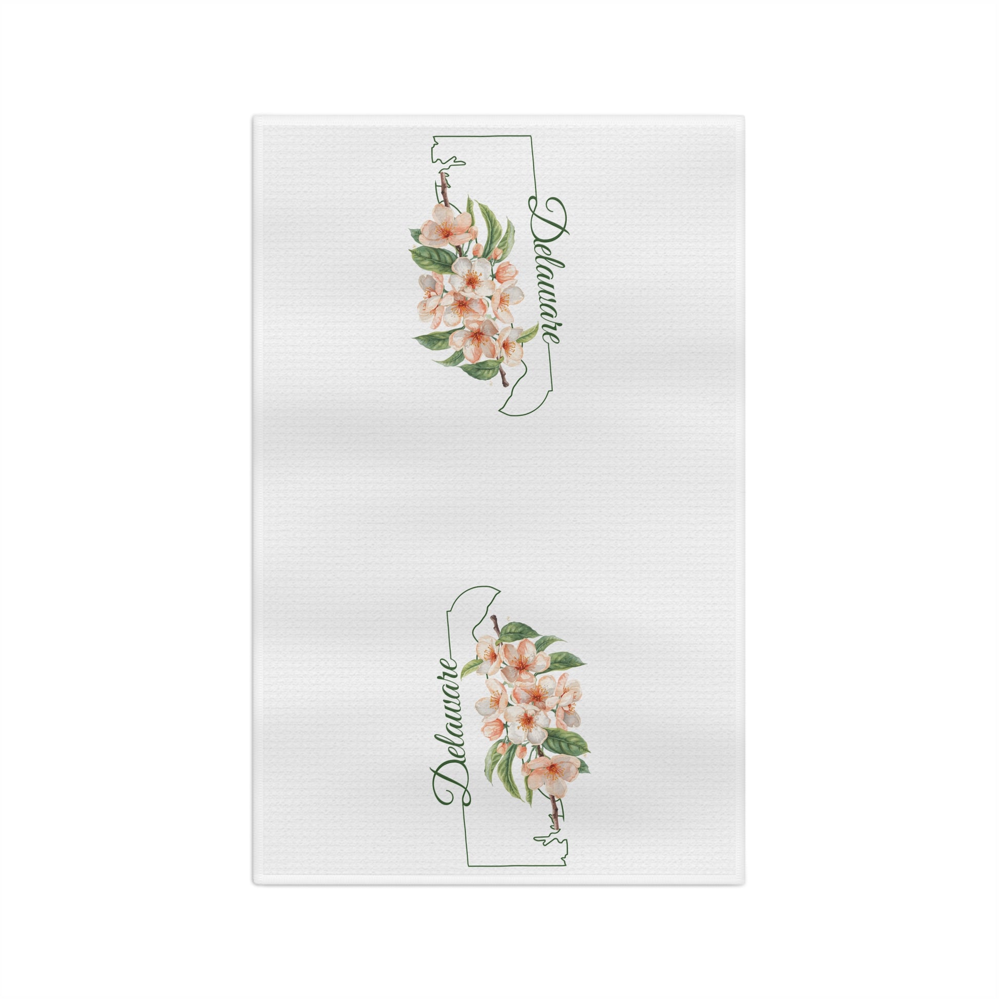 White microfiber tea towel with two Delaware state silhouettes, each adorned with delicate peach blossoms.