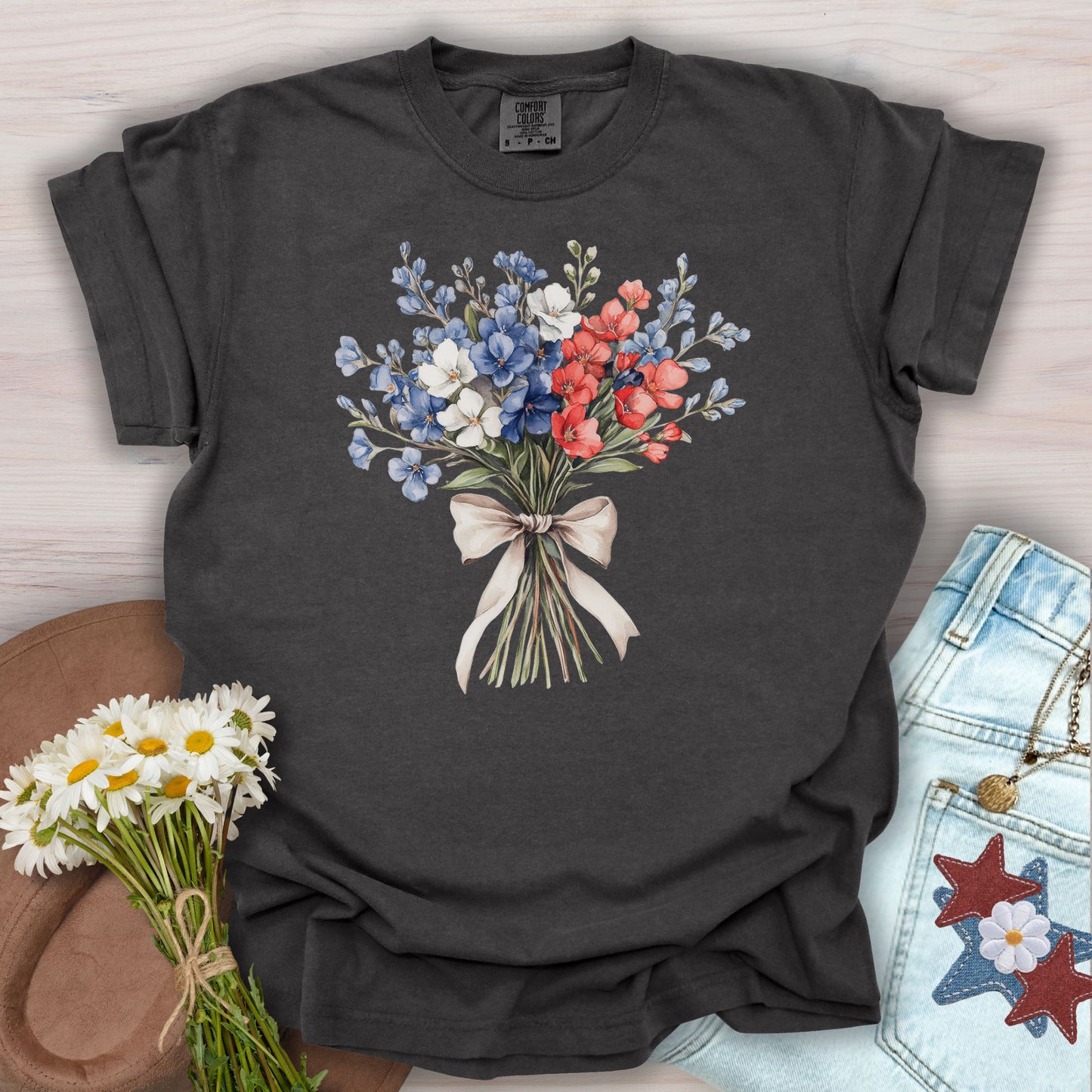 Pepper S t-shirt with a delicate patriotic bouquet of red, white, and blue flowers tied with a ribbon.