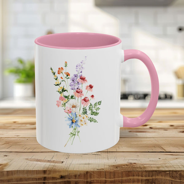 White 11oz ceramic mug with pink handle and interior, featuring a vibrant watercolor bouquet of summer wildflowers.
