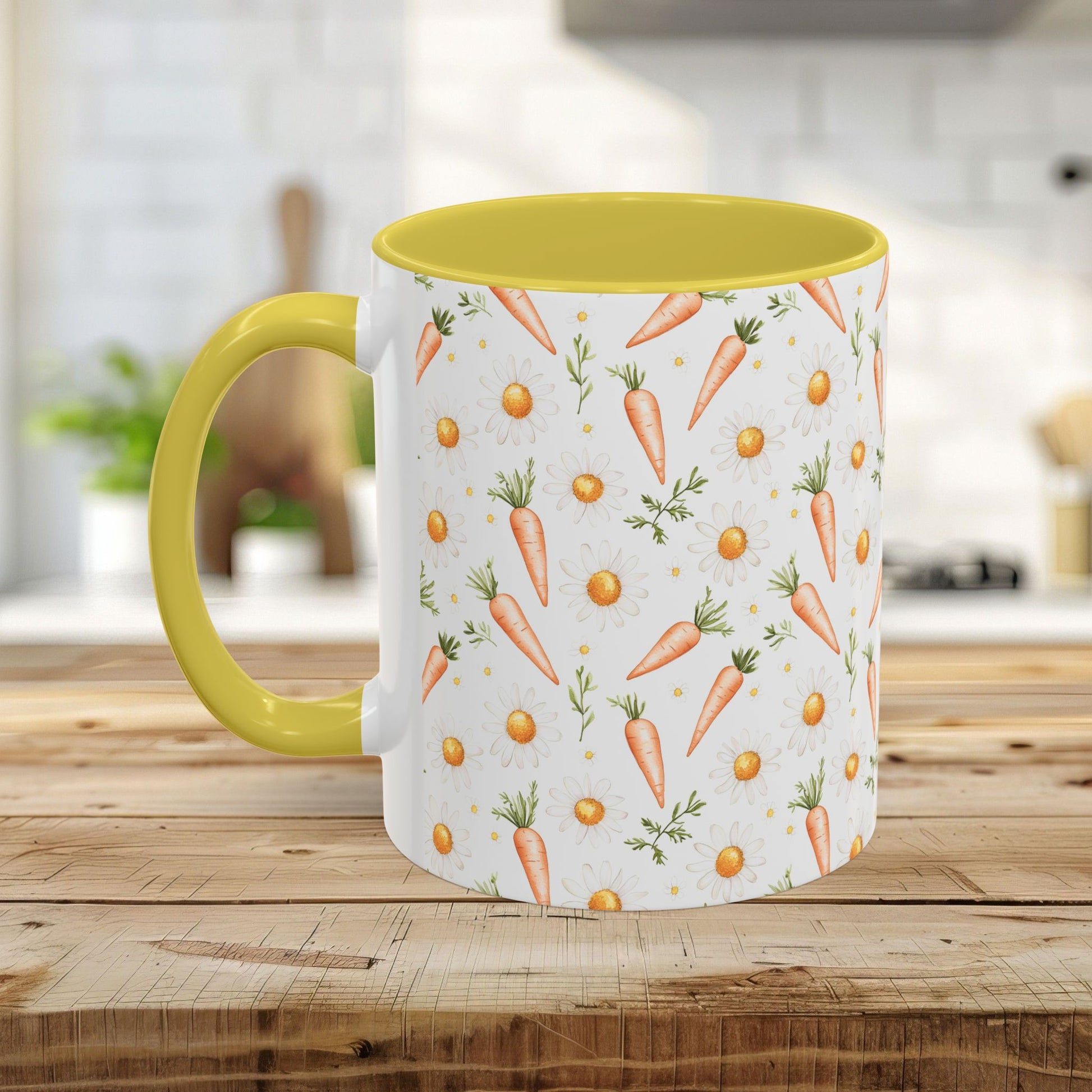 White ceramic mug with watercolor carrots and daisies, yellow interior and handle, on a wooden surface.