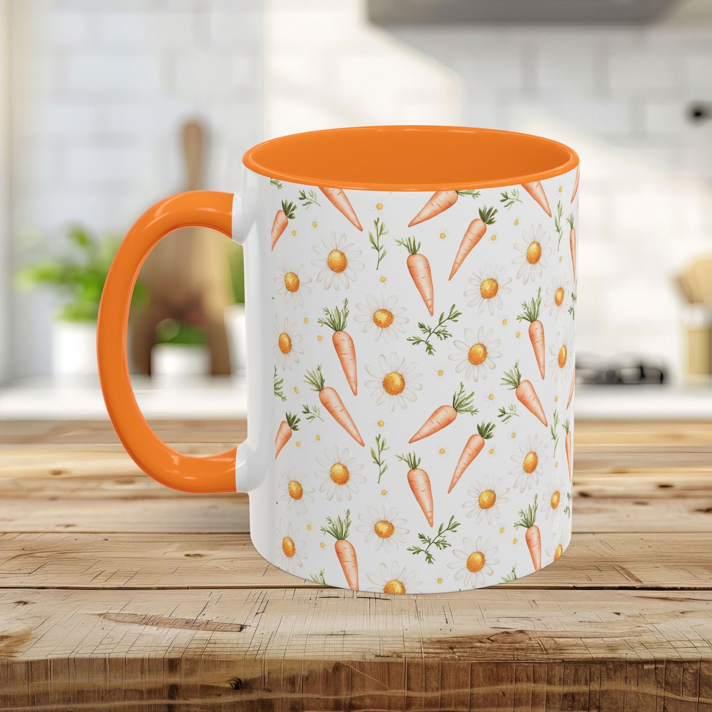 White ceramic mug with orange interior and handle, featuring a watercolor carrot and daisy pattern.