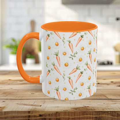 White ceramic mug with orange interior and handle, featuring a watercolor carrot and daisy pattern.