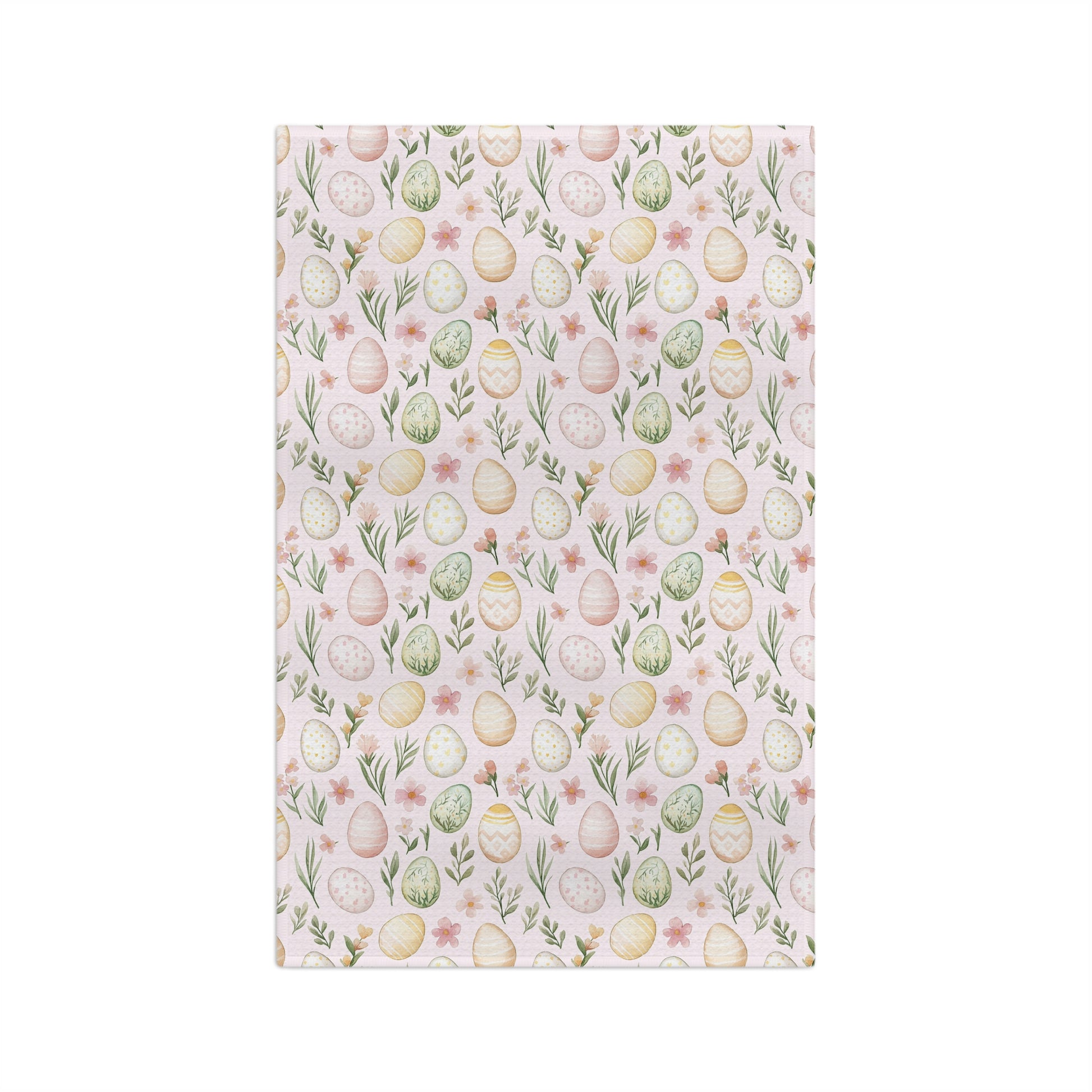 Pastel pink microfiber tea towel with watercolor Easter eggs, sprigs, and flowers.