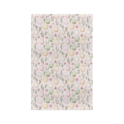 Pastel pink microfiber tea towel with watercolor Easter eggs, sprigs, and flowers.