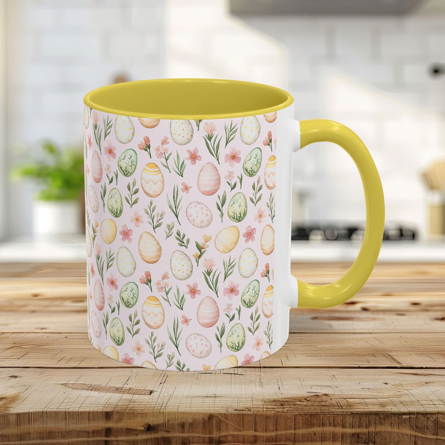 11oz ceramic mug with yellow handle/interior and a pastel watercolor Easter egg pattern.