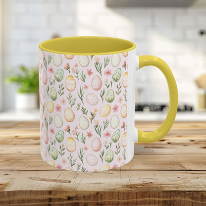 11oz ceramic mug with yellow handle/interior and a pastel watercolor Easter egg pattern.