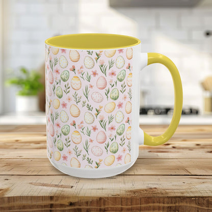 15oz ceramic mug with a pastel watercolor egg pattern, yellow interior, and C-shaped handle.