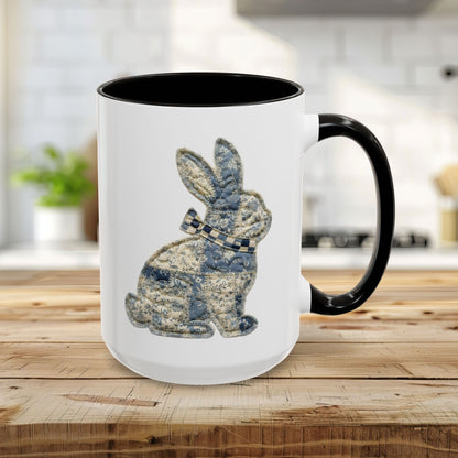 15oz glossy ceramic mug with a black handle and interior, featuring a blue patchwork bunny illustration.
