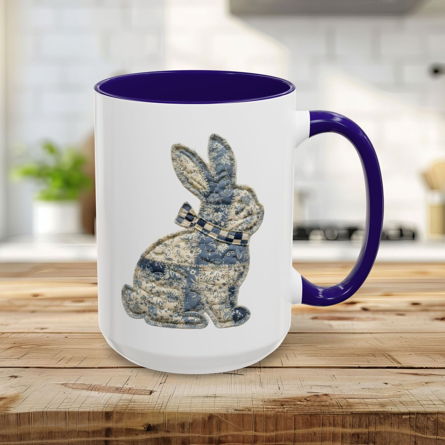 15oz glossy ceramic mug with a blue interior and handle, featuring a textured patchwork bunny illustration.