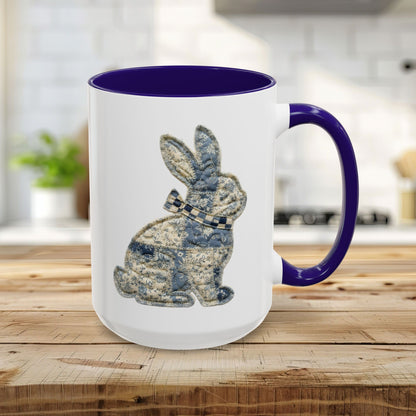 15oz glossy ceramic mug with a blue interior and handle, featuring a textured patchwork bunny illustration.