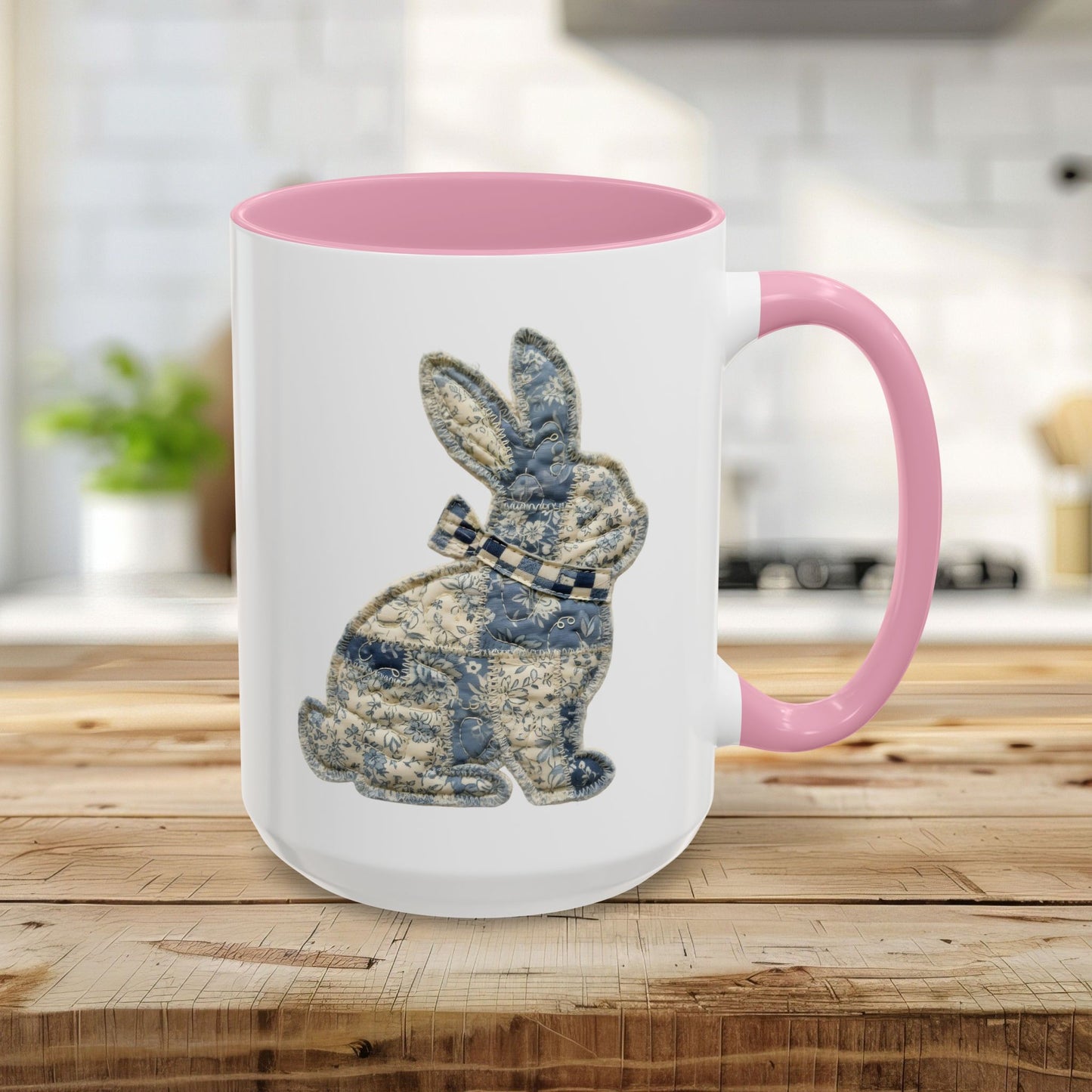 15oz white ceramic mug with pink handle and interior, featuring a blue patchwork bunny design.