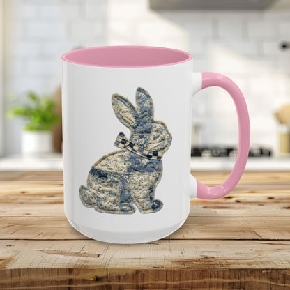 15oz white ceramic mug with pink handle and interior, featuring a blue patchwork bunny design.