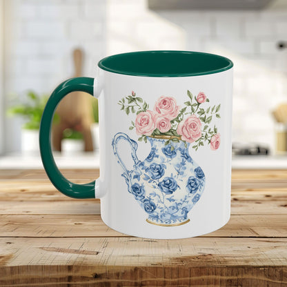 White ceramic mug with green interior and handle, featuring a blue-and-white rose pitcher design.