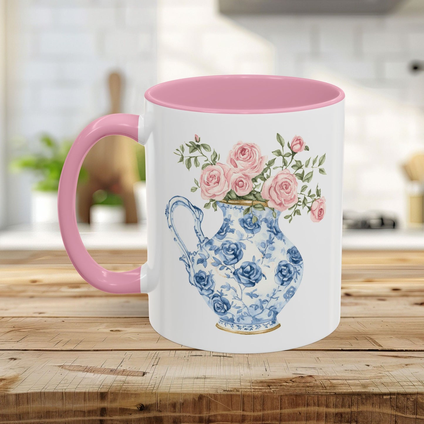 White ceramic mug with pink handle and interior, featuring a blue-and-white pitcher with pink roses.
