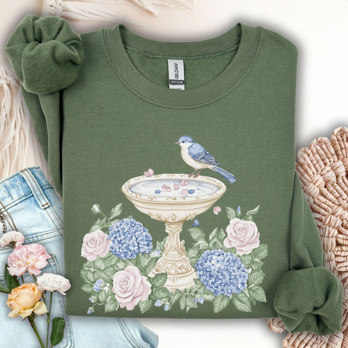 Military Green Gildan sweatshirt with a watercolor bird bath, blue bird, pink roses, and blue hydrangeas.