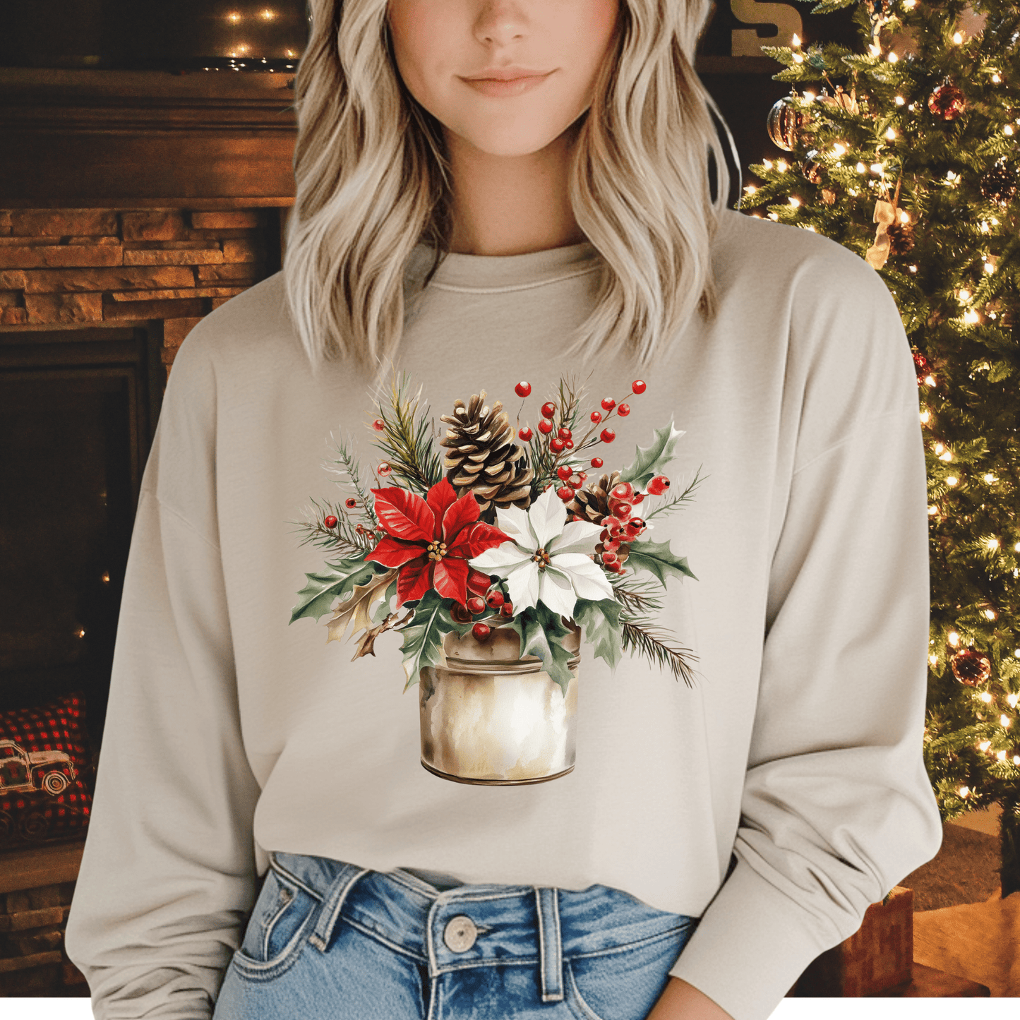 Blonde woman in a beige long sleeve tee with a watercolor farmhouse Christmas bouquet in a rustic metal jar.