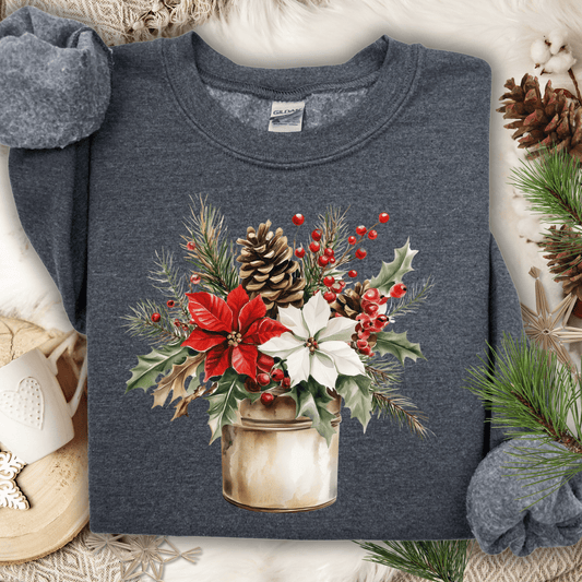 Dark Heather Gildan sweatshirt with watercolor poinsettia bouquet in a rustic metal jar, surrounded by holiday decor.