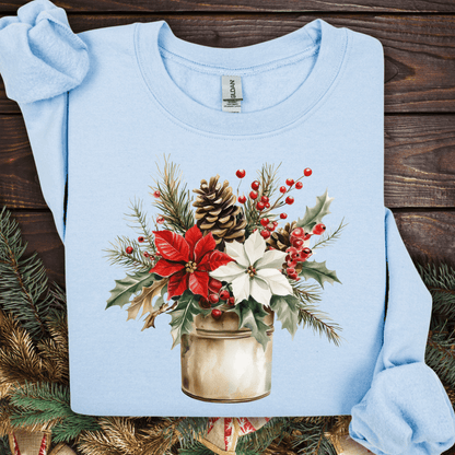 Light blue Gildan sweatshirt with a watercolor Christmas bouquet in a rustic metal jar, featuring red and white poinsettias.