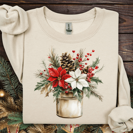 Sand Gildan sweatshirt with watercolor poinsettia, evergreen, and berry bouquet in a rustic metal jar.