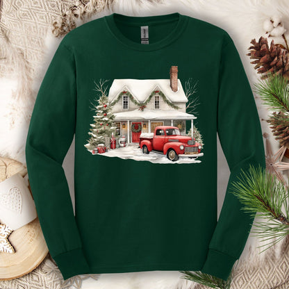 Forest Green long sleeve tee with a watercolor farmhouse Christmas scene: red truck, snow, and evergreens.