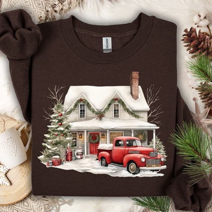 Dark Chocolate Gildan sweatshirt with a watercolor farmhouse Christmas scene, red vintage truck, and snow.
