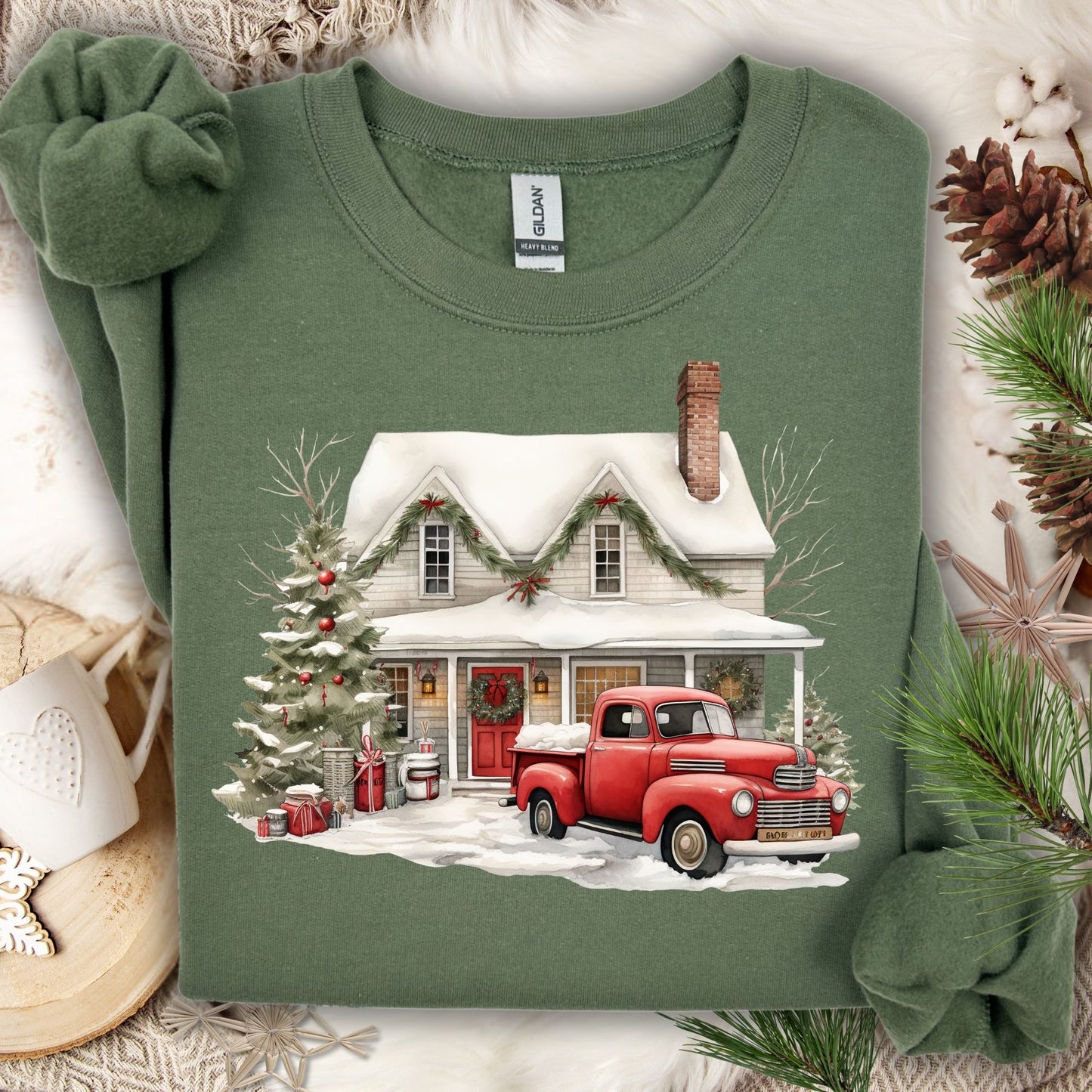Military Green Gildan sweatshirt with a watercolor farmhouse, red vintage truck, and Christmas tree in snow.