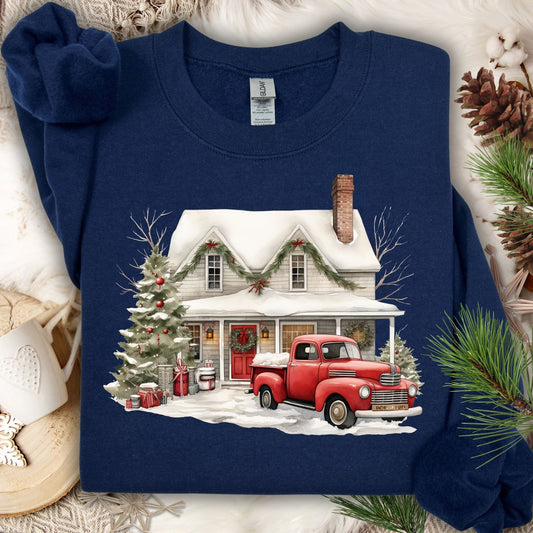 Navy Gildan sweatshirt with a watercolor farmhouse, red vintage truck, and Christmas tree in snow.