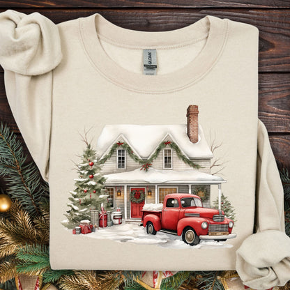 Sand Gildan sweatshirt with a watercolor farmhouse, red vintage truck, and Christmas tree in snow.