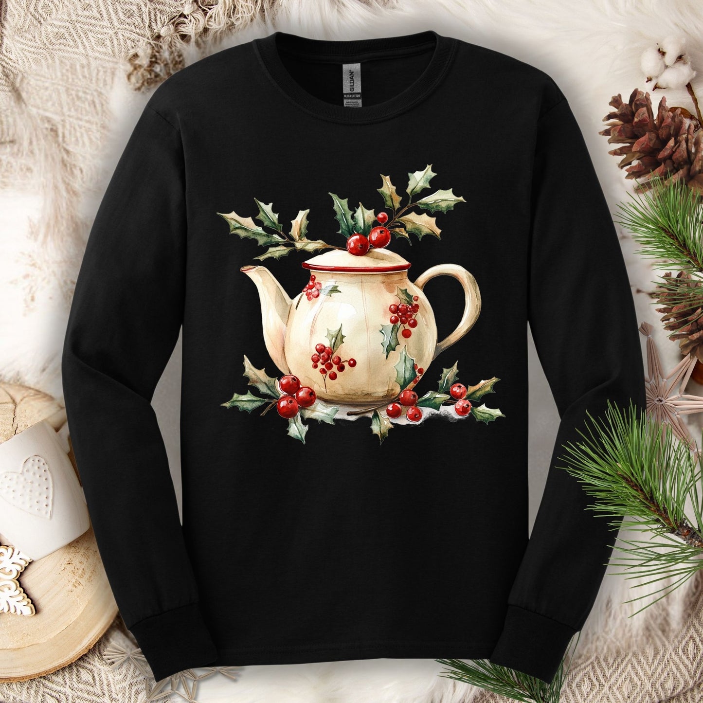 Black long sleeve tee with a watercolor farmhouse Christmas teapot, holly, and evergreens design.