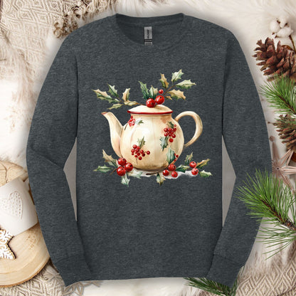Dark Heather long sleeve tee with a watercolor farmhouse Christmas teapot wrapped in holly and evergreens.