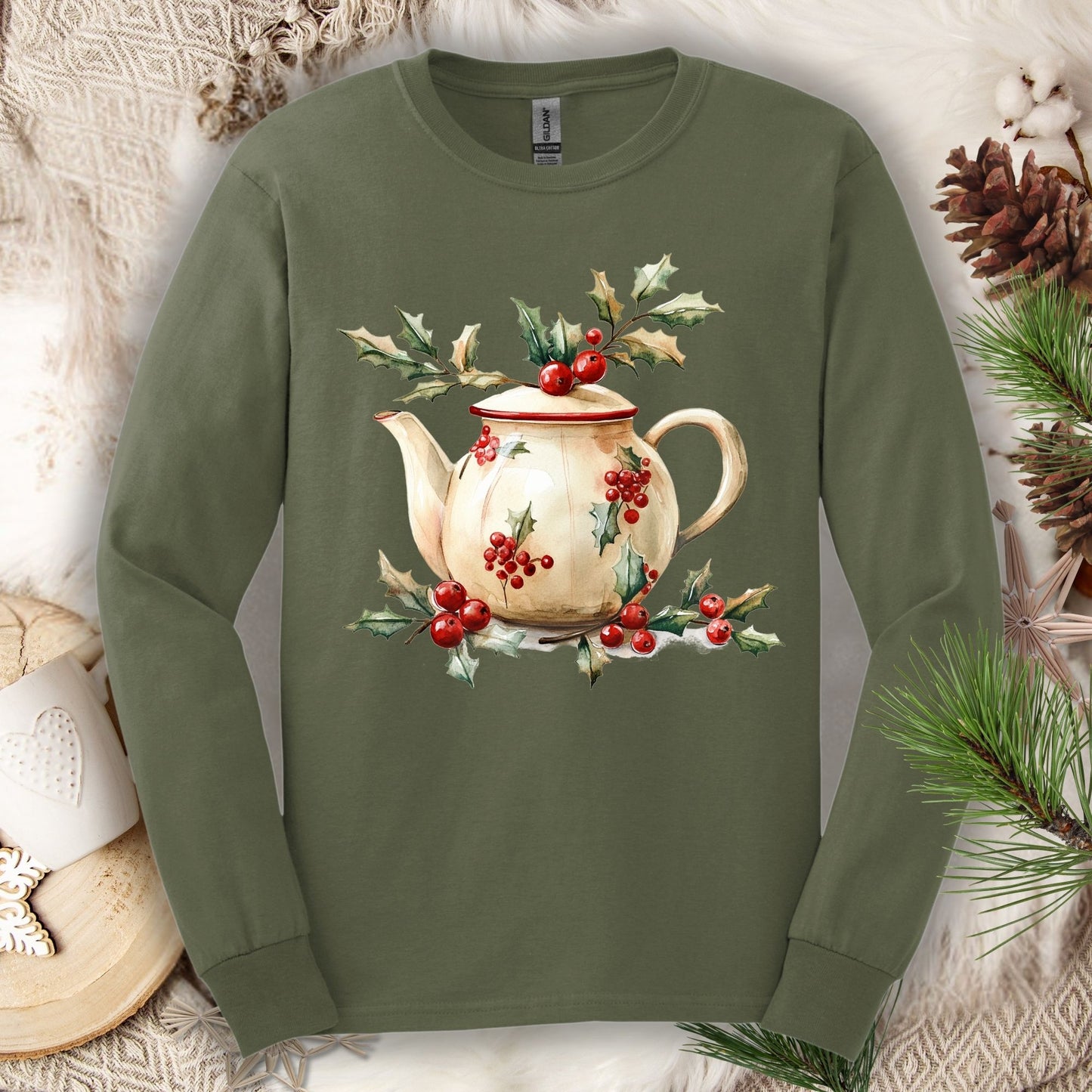 Military green long sleeve tee with a watercolor farmhouse Christmas teapot and holly design.